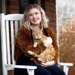 a woman with an adopted ginger adult cat