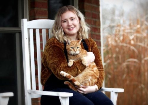 a woman with an adopted ginger adult cat