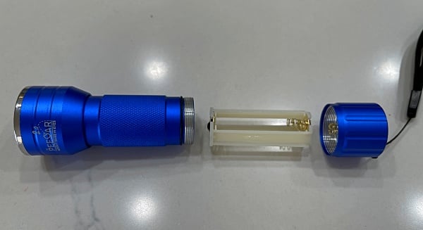 The PeeDar 2.0 Blacklight flashlight that I purchased, opened up showing the battery compartment.